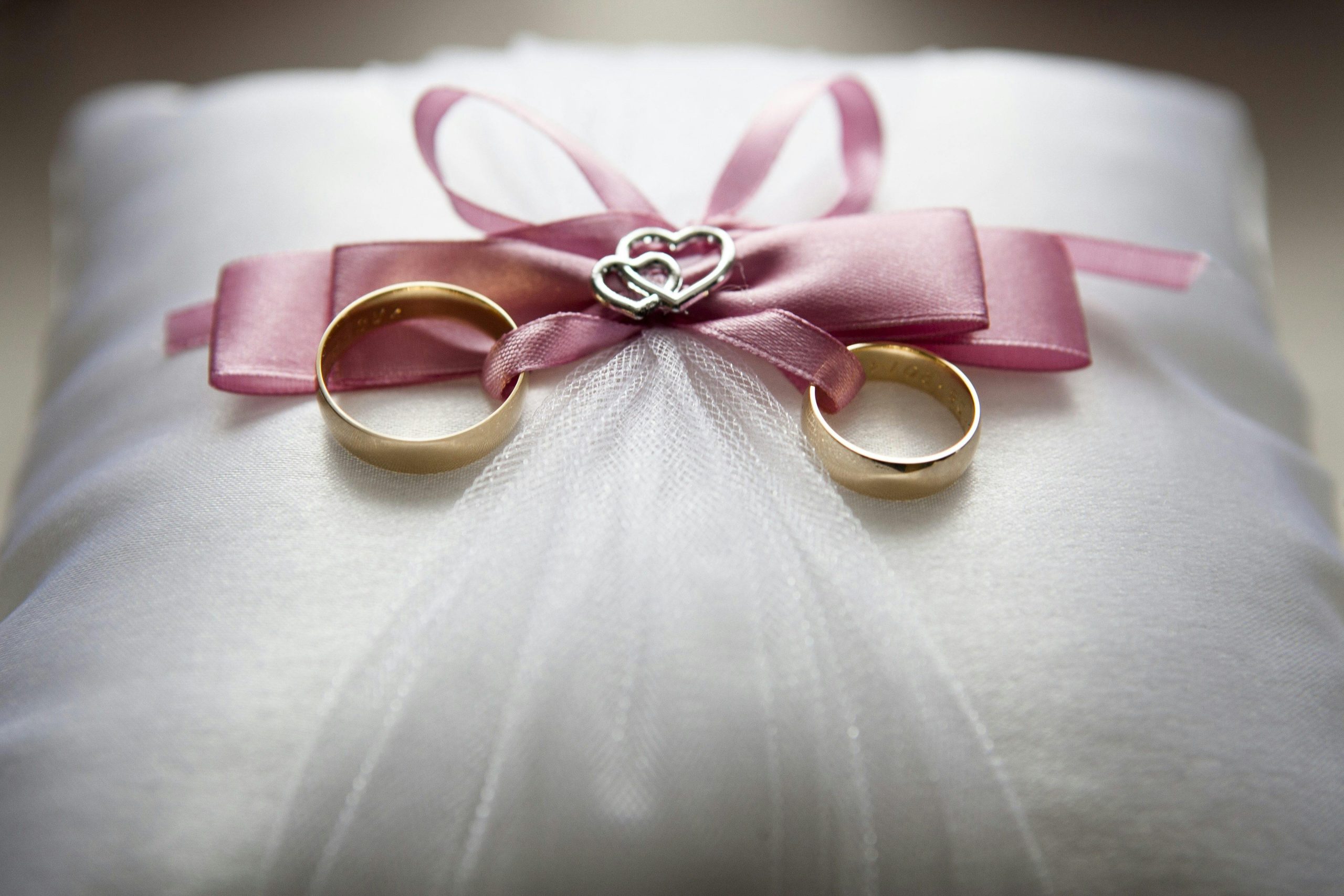 Photo by Pixabay: https://www.pexels.com/photo/selective-focus-photography-of-silver-colored-engagement-ring-set-with-pink-bow-accent-on-throw-pillow-265856/